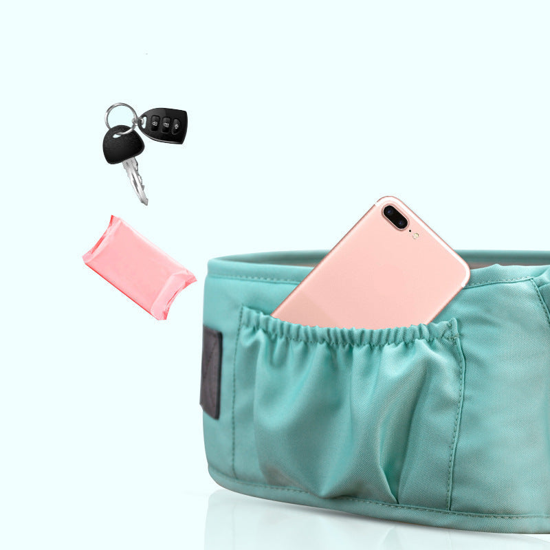 Baby carrier with a pink phone and key on a white background