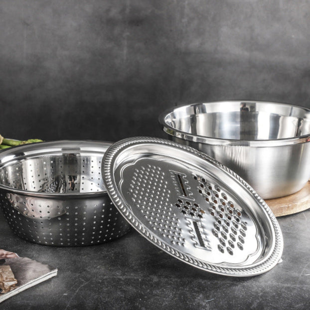 Stainless steel multi-functional grating basin set on a dark surface with a blurred background