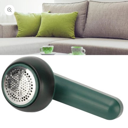Green fabric hair remover with a blurred living room background