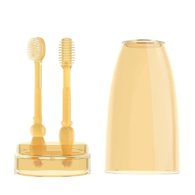 Gold-colored dental cleaning tools with a clear container on a white background