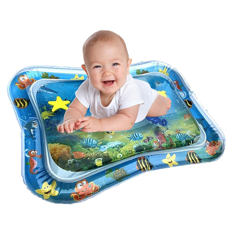 Baby playing on an inflatable water mat with ocean design