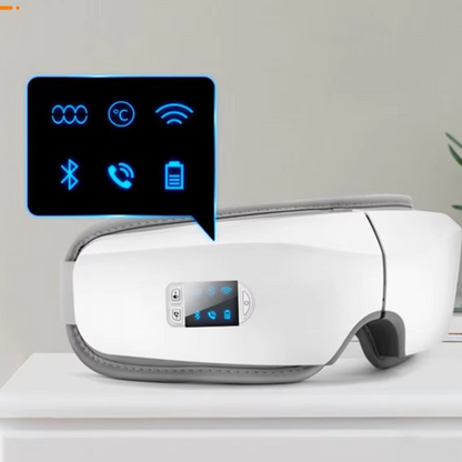 White electronic eye massager  device with digital display on a light gray background