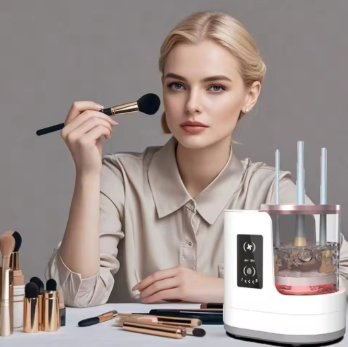 Woman holding a makeup brush with an electric makeup brush cleaner device and various brushes on a table.