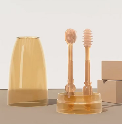 Set of newborn baby oral cleaning tools including a cup, brush, and holder on a light background.